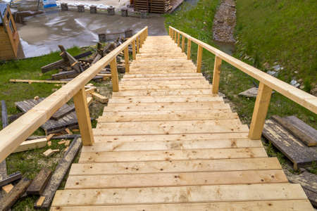 New wooden stairs outdoors. Carpenters work.