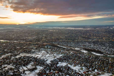 Top view of city suburbs or small town nice houses on winter morning on cloudy sky background. Aerial drone photography concept.の写真素材