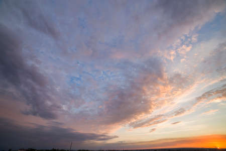 Dramatic sunset sky with orange clouds.