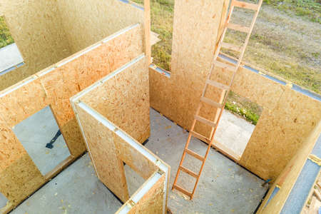 Construction of new and modern modular house. Walls made from composite wooden sip panels with foam insulation inside. Building new frame of energy efficient home concept.の写真素材
