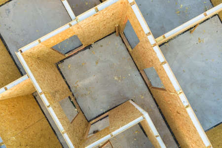 Construction of new and modern modular house. Walls made from composite wooden sip panels with foamboard insulation inside. Building new frame of energy efficient home concept.の写真素材