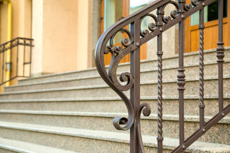 Detail of a house facade. New granite stairs with metal railings.の写真素材