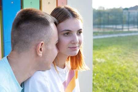 Happy young couple together outdoors. Redhead girl and boy having fun with each other.の写真素材