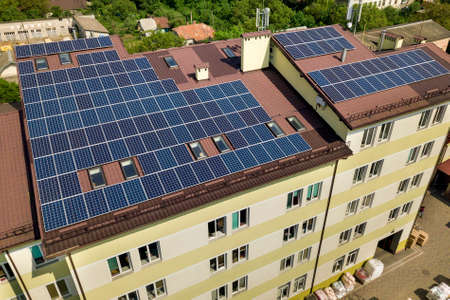 Aerial view of many solar panels mounted of industrial building roof.の写真素材