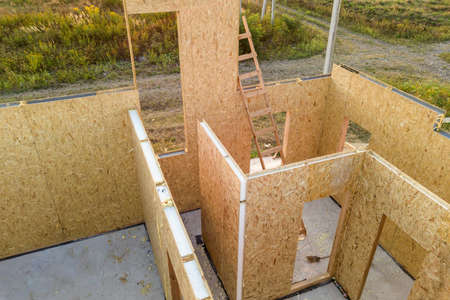 Construction of new and modern modular house. Walls made from composite wooden sip panels with foam insulation inside. Building new frame of energy efficient home concept.の写真素材