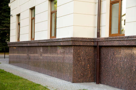 Close up view of part of a building facade with the surface of granite wall. Natural stone materials.の写真素材