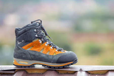 A leather trekking hiking winter boot on blurred backgroundの写真素材