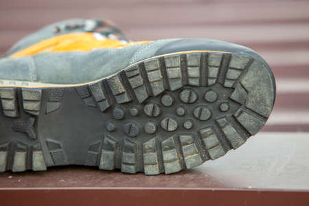 A leather trekking hiking winter boot on blurred background