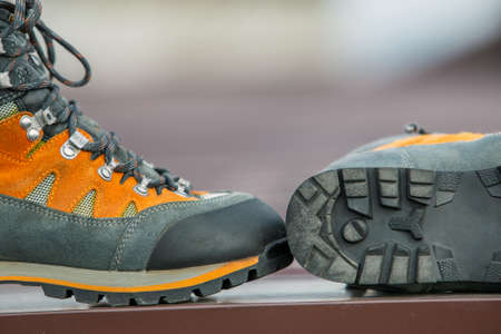 A pair of leather trekking hiking winter boots on blurred backgroundの写真素材