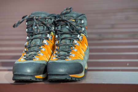 A pair of leather trekking hiking winter boots on blurred background