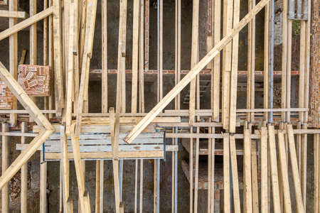 Top down aerial view of a house under construction with wooden roof frame.の写真素材