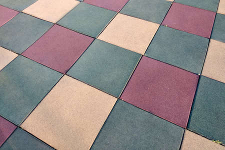 Close up of soft rubber tiles for covering at outdoor gym of stadium at preschool yard.の写真素材