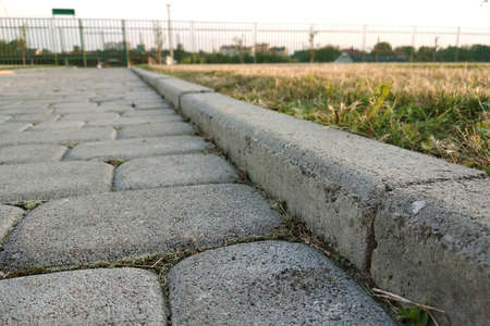 Close-up of slab stone paved path way at park or backyard. Walkway footpath road at house yard garden.の写真素材