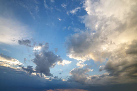Blue sky covered with white puffy clouds.