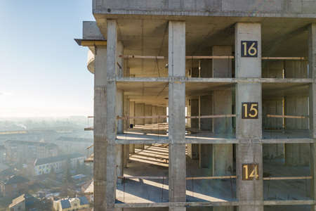 Aerial view of concrete frame of tall apartment building under construction in a city.の写真素材