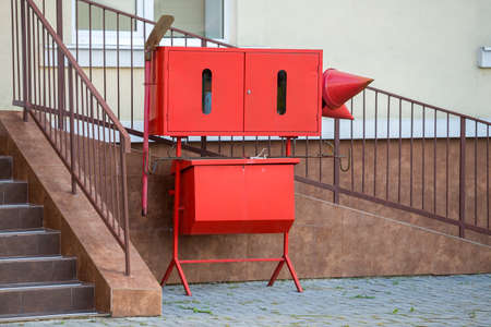 Red fire protection utensils outside a building.の写真素材