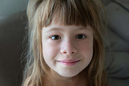 Close-up portrait of happy smiling little girl with long hair.の写真素材