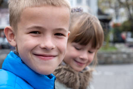 Closeup portrait of two children boy and girl tofether outdoors.の写真素材