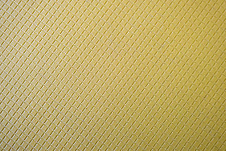 Close up of abstract yellow background with geometric pattern.