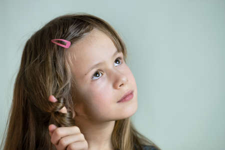 Close-up portrait of happy smiling little girl with long hair.