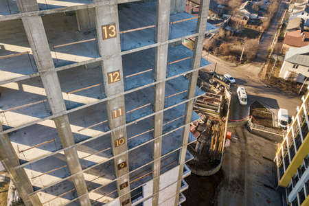 Aerial view of concrete frame of tall apartment building under construction in a city.の写真素材