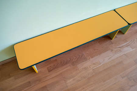 Yellow benches inside a school sports gym.