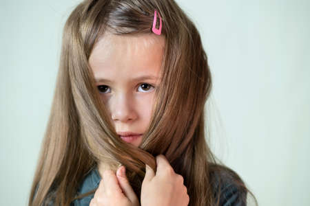 Close-up portrait of happy smiling little girl with long hair.の写真素材