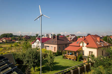 Aerial view of a new autonomous house with solar panels, water heating radiators on the roof and...