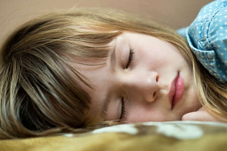 Portrait of a pretty child girl sleeping in bed.