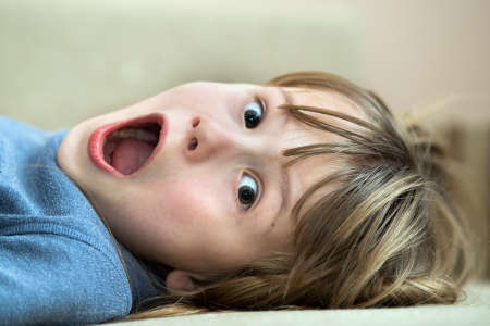 Portrait of a pretty child girl with open mouth in amazement.