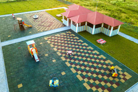 Aerial view of new alcove in kindergarten play yard with red tiled roof for outdoor children...