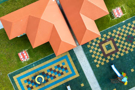 Aerial view of new alcove in kindergarten play yard with red tiled roof for outdoor children activities.の写真素材