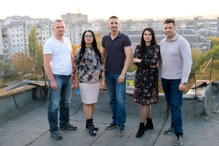 Group of diverce young people standing together outdoors on a warm sunny day.の写真素材