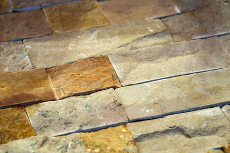 Closeup detail of limestone tiled wall of floor.