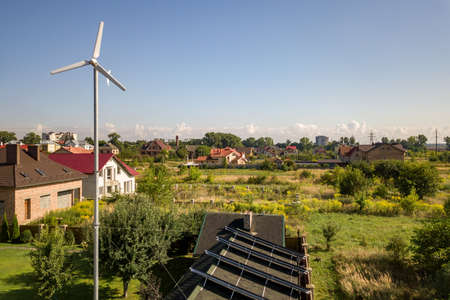 Aerial view of a new autonomous house with solar panels, water heating radiators on the roof and...