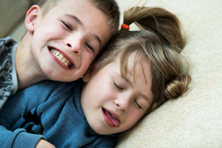 Two children boy and girl fooling around having fun together. Happy childhood concept.の写真素材