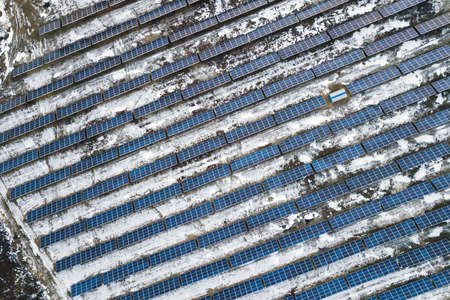 Blue solar photo voltaic panels system producing renewable clean energy in rural area in winter.の写真素材