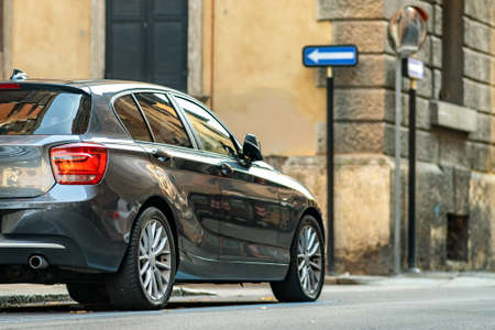 Modern cars parked on city street side in residential discrict. Shiny vehicles parked by the curb....
