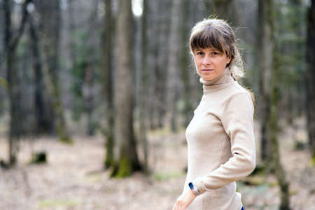 Portrait of young attractive woman enjoying warm day in early spring outdoors.の写真素材