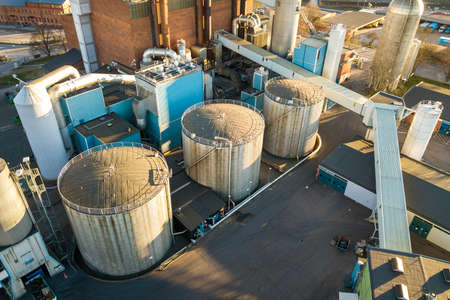 Aerial view of big fuel reservoirs in petroleum industrial zone and metal exhaust pipes of oil refinery factory.の写真素材