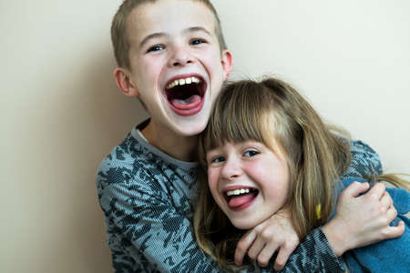 Two children boy and girl fooling around having fun together. Happy childhood concept.の写真素材