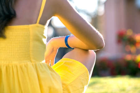 Young woman relaxing outdoors on sunny summer day. Happy lady sitting on green grass lawn daydreaming thinking. Calm girl enjoying fresh air relaxing and meditating.の写真素材