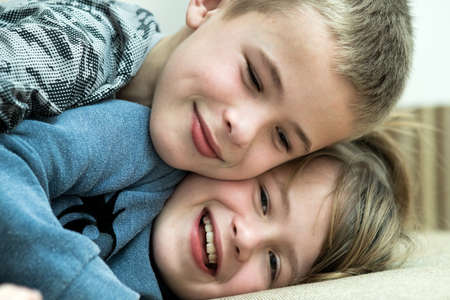 Two children boy and girl fooling around having fun together. Happy childhood concept.の写真素材