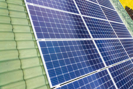 Aerial top view of new modern residential house cottage with blue shiny solar photo voltaic panels...