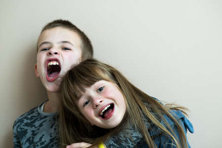 Two children boy and girl fooling around having fun together. Happy childhood concept.