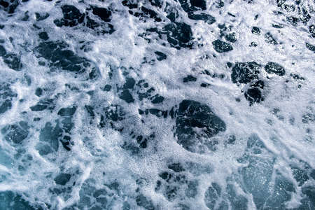 Top down aerial view of sea water surface. White foam waves texture as natural background.の写真素材