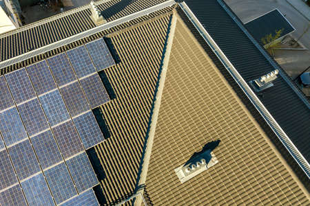 Aerial view of solar photovoltaic panels on a roof top of residential building block for producing clean electric energy. Autonomous housing concept.の写真素材