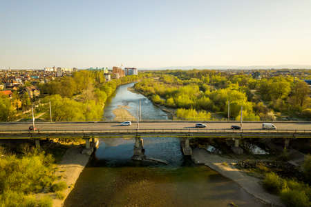 Aerial view of Ivano-Frankivsk city, Ukraine with Bystrytsia river and tall residential buildings under construction in distance.の写真素材