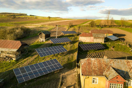 Aerial top down view of solar panels in green rural village yard.の写真素材