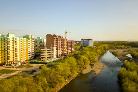 Aerial view of tall residential apartment buildings under construction and Bystrytsia river in Ivano-Frankivsk city, Ukraine.の写真素材